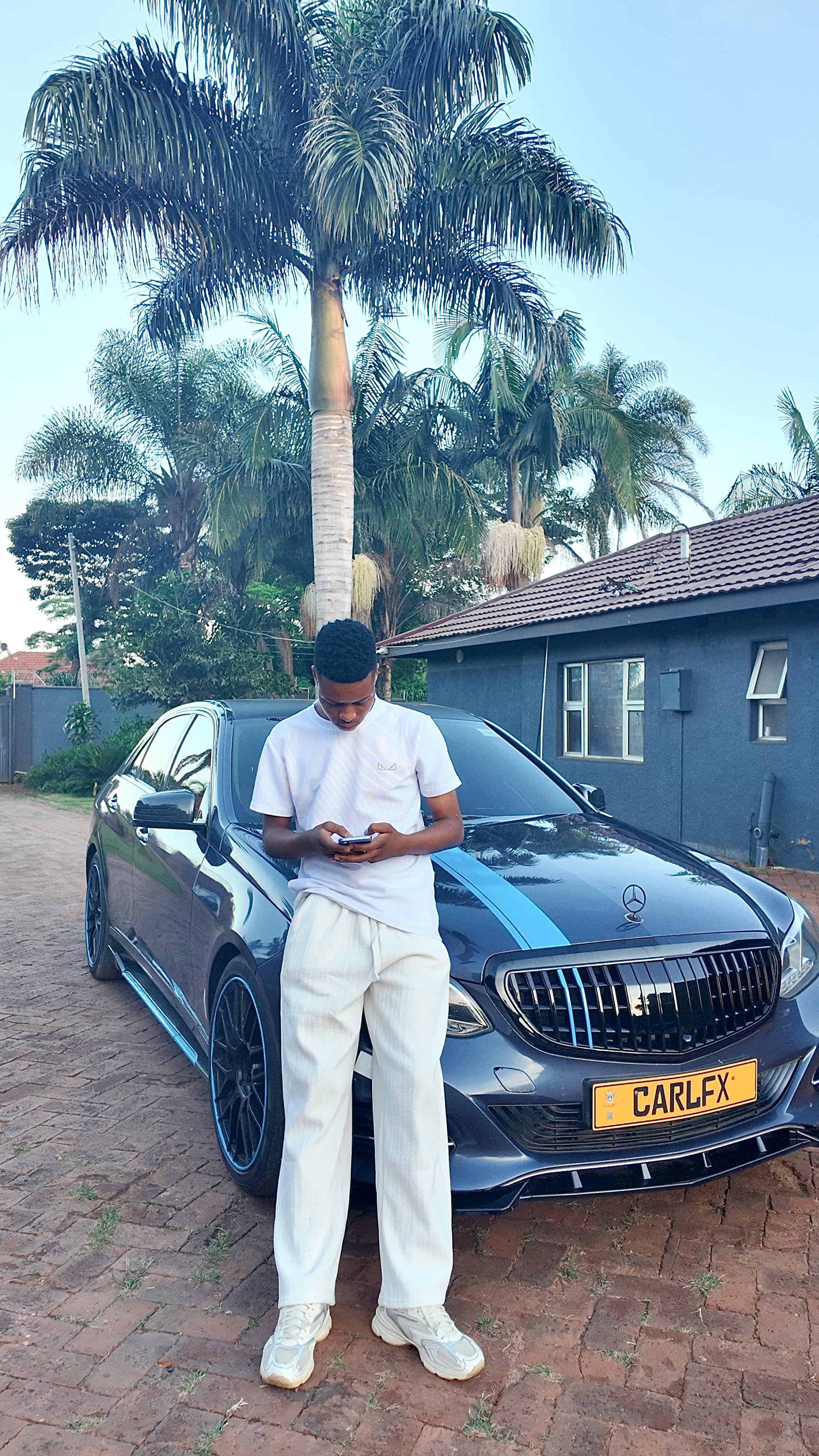 Carl FX standing in front of car